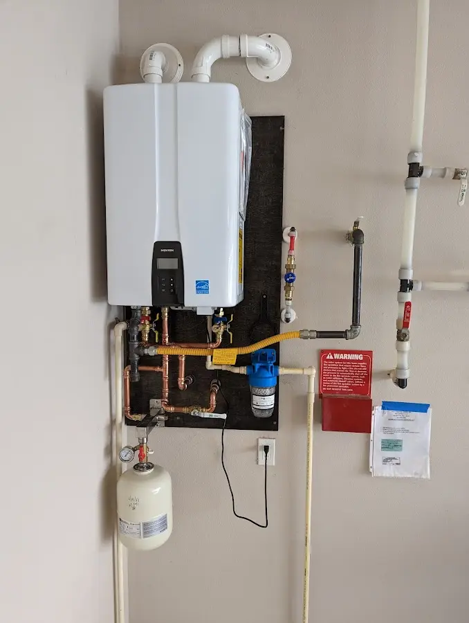 Professional plumber installing copper piping in a Pine Grove home